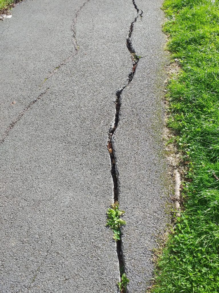 Badly cracked pavement in Hookes Way