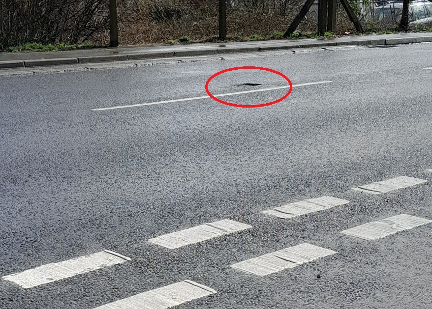 Pothole in Horsebridge Hill opposite Hogan Road